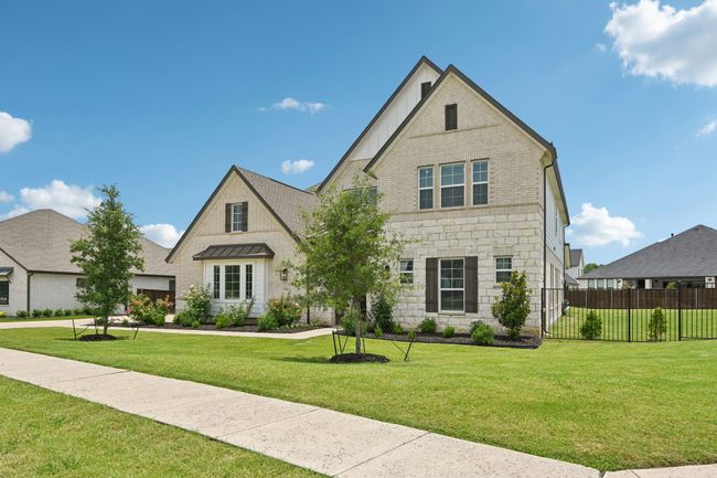 View of front of property with board and batten siding, stone siding, and brick siding | Image 4