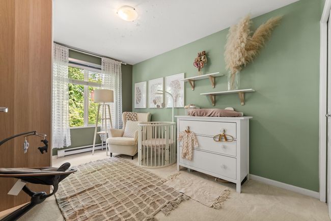 Carpeted bedroom with a baseboard heating unit, baseboards, and a nursery area | Image 25
