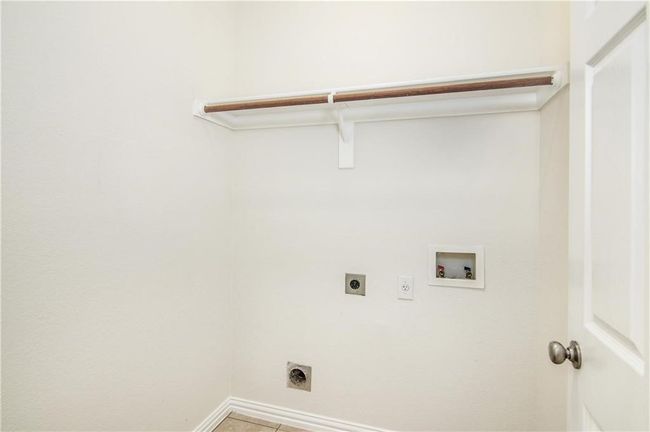Laundry room featuring electric dryer hookup and hookup for a washing machine | Image 14