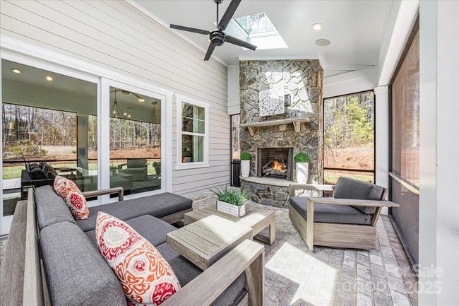 Private, screened in back porch with a gas fireplace, creates the perfect indoor-outdoor space to relax and unwind | Image 16