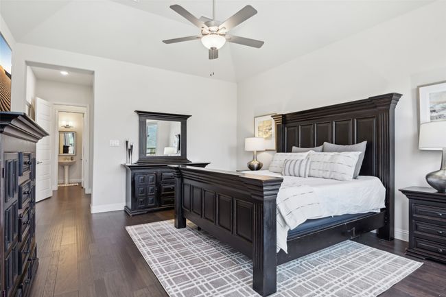 Bedroom featuring dark wood-style floors, a ceiling fan, and lofted ceiling | Image 23