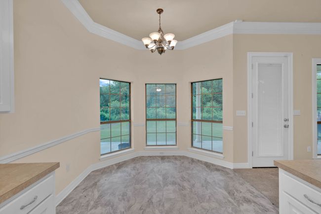 Unfurnished dining area with a chandelier and ornamental molding | Image 13
