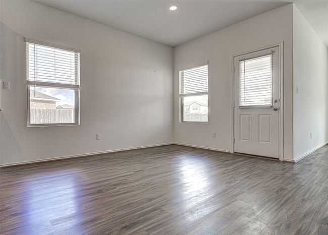 Empty room with plenty of natural light, dark wood-type flooring, and baseboards | Image 7
