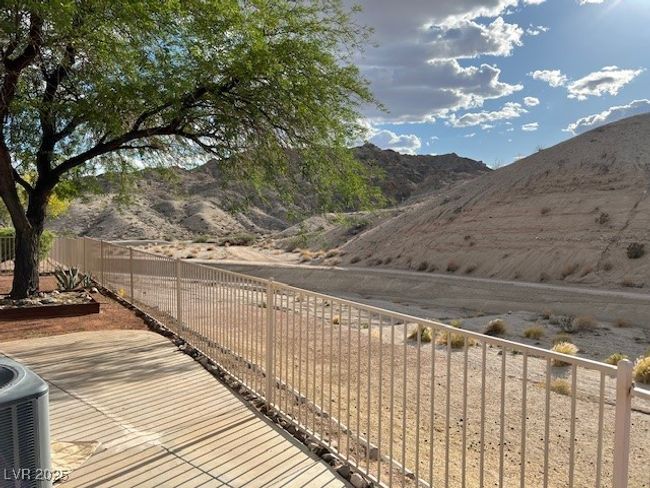 Community pool with a patio area, fence, and a mountain view | Image 37