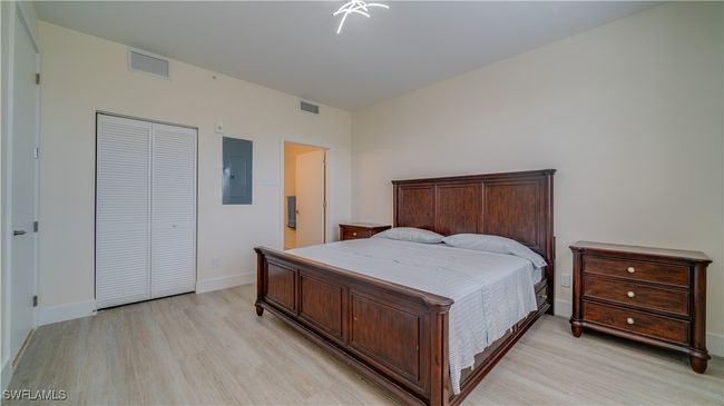 Bedroom with a closet, electric panel, and light wood-type flooring | Image 16