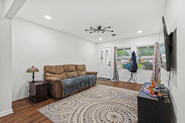 Living room featuring wood finished floors, recessed lighting, and baseboards | Image 5