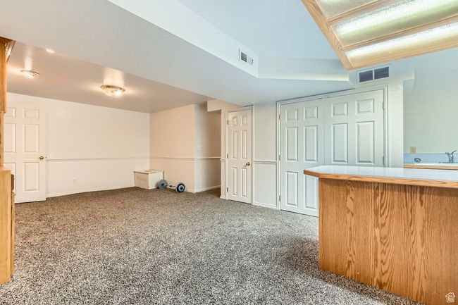 Finished below grade area featuring carpet and baseboards | Image 20