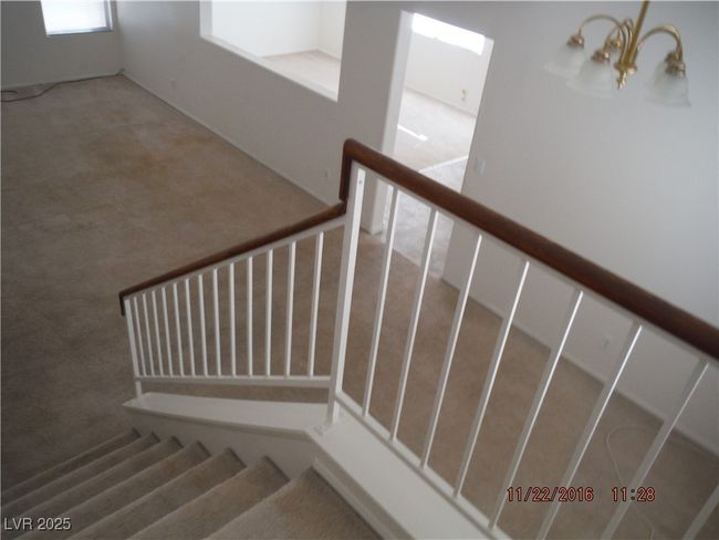 Staircase featuring a chandelier and carpet flooring | Image 5