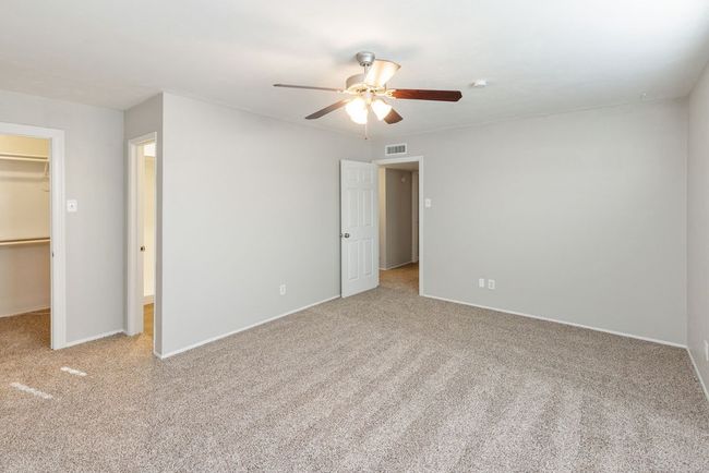 Unfurnished bedroom with a closet, carpet flooring, visible vents, and a spacious closet | Image 21