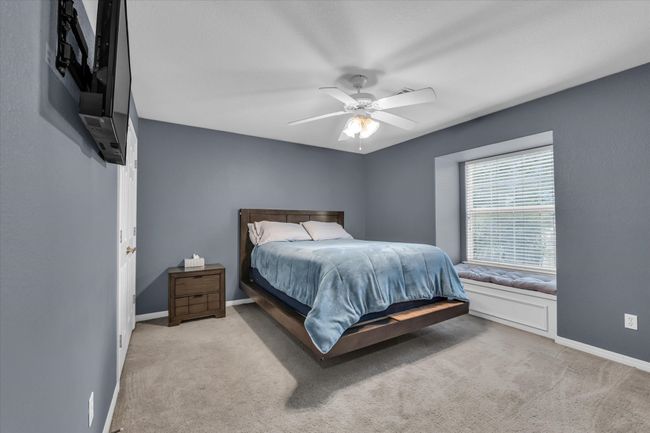 Bedroom featuring carpet flooring, baseboards, and a ceiling fan | Image 15