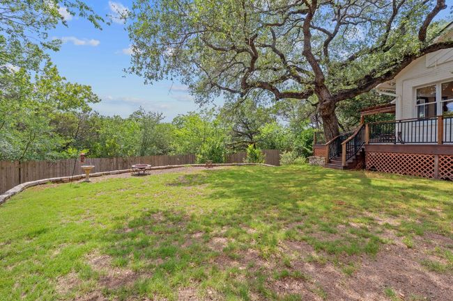 Fenced backyard featuring a fire pit, a deck, and stairway | Image 38