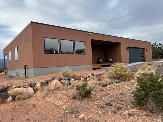 View of front of home featuring stucco siding and a garage | Image 46