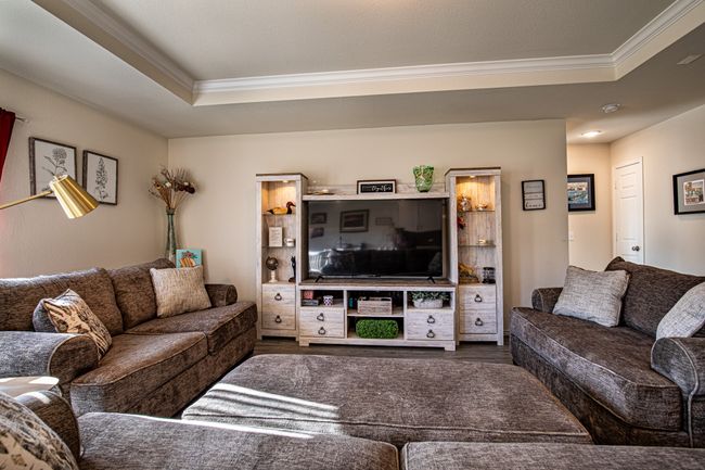 Living room featuring crown molding, a raised ceiling, and wood finished floors | Image 4