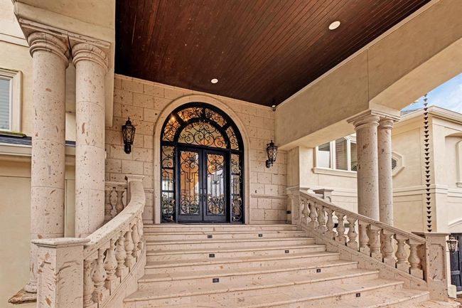 lighted staircase with columns and steps made of Cantera stone, Wrought Iron Doors | Image 10
