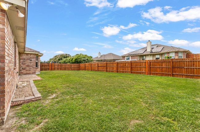 View of fenced backyard | Image 33