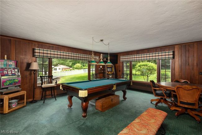 Game room featuring a textured ceiling, carpet flooring, billiards, and radiator heating unit | Image 19