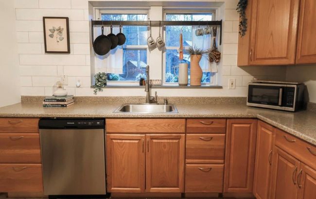 Kitchen featuring sink and appliances with stainless steel finishes | Image 8