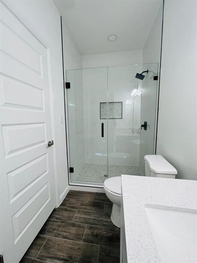 Bathroom featuring sink, toilet, and walk in shower | Image 22