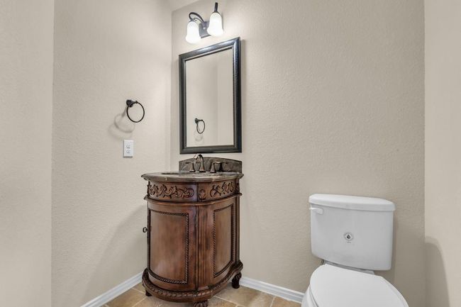 Conveniently located between the media room and game room, this upstairs powder room offers stylish functionality for guests and family alike adding convenience to the upper-level entertainment space. | Image 31