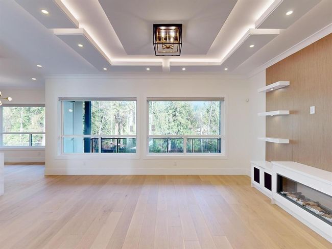 Spare room with light wood-style flooring, a tray ceiling, recessed lighting, and ornamental molding | Image 15