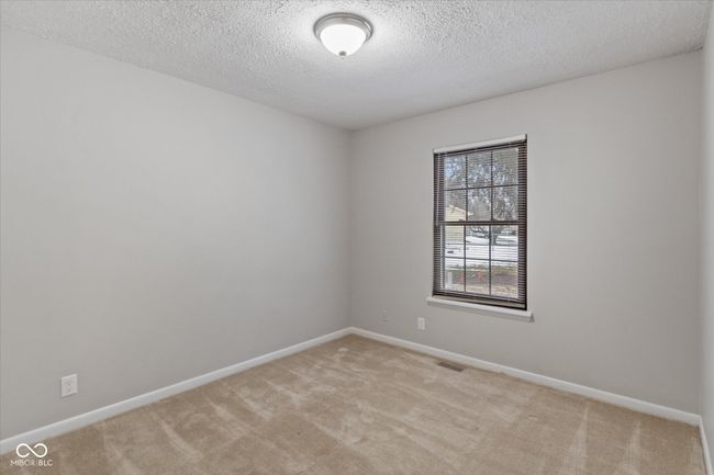 unfurnished room with light carpet and a textured ceiling | Image 10