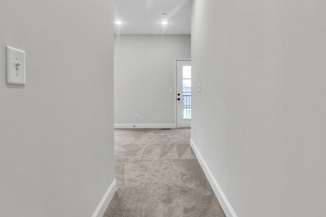 As you enter owner's retreat, you notice the soaring ceilings, multiple windows and lots of light streaming in with the primary bath and owner's walk-in closet to the left. | Image 27