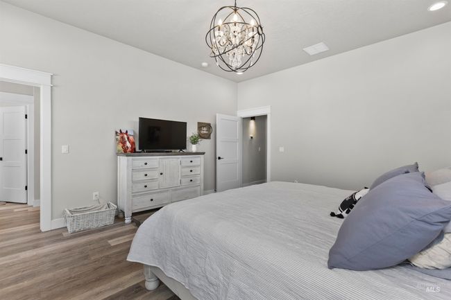 Bedroom with wood finished floors, a chandelier, and recessed lighting | Image 25