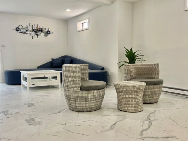 Sitting room with a baseboard radiator, recessed lighting, and marble finish floor | Image 43