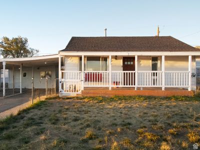 View of front of home featuring a carport and a porch | Image 1