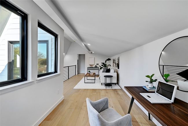 Office space featuring light wood-type flooring and vaulted ceiling | Image 17