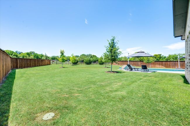 View of yard with a patio, a fenced backyard, and a fenced in pool | Image 36