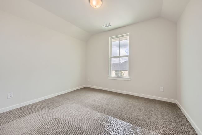 Carpeted empty room featuring lofted ceiling | Image 23