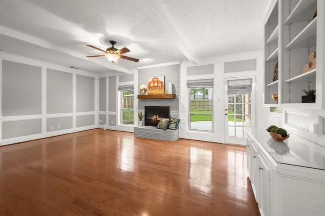 Spacious family room features built-in cabinets and shelving—perfect for showcasing your treasured collections and creating a cozy, organized living space. | Image 15