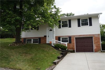 Split foyer home with a garage and a front yard | Image 1