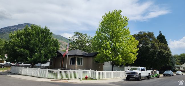View of asphalt road featuring sidewalks and a mountain view | Image 51