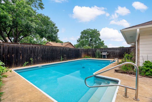 View of swimming pool with a fenced backyard, a fenced in pool, and a patio area | Image 29