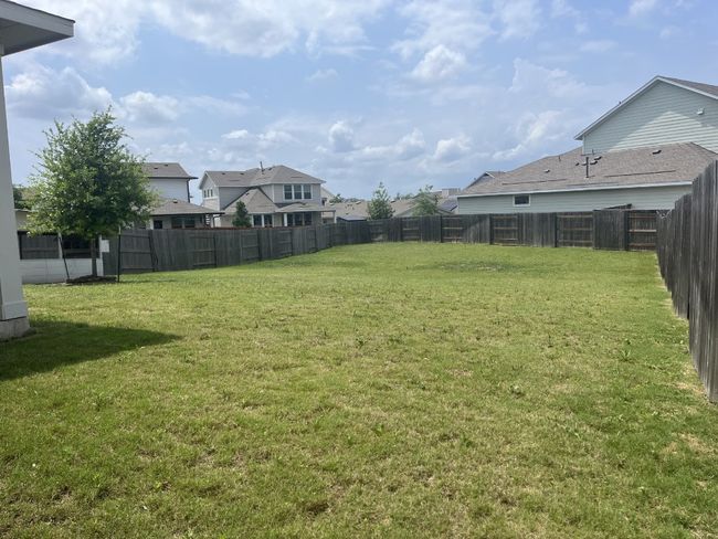 View of yard with a fenced backyard and a residential view | Image 8