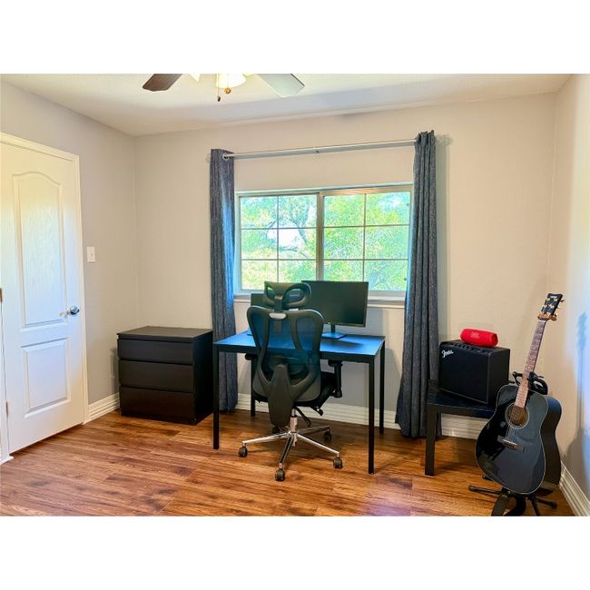 Bedroom number four on the upper level has ceiling fan and walk-in closet | Image 35