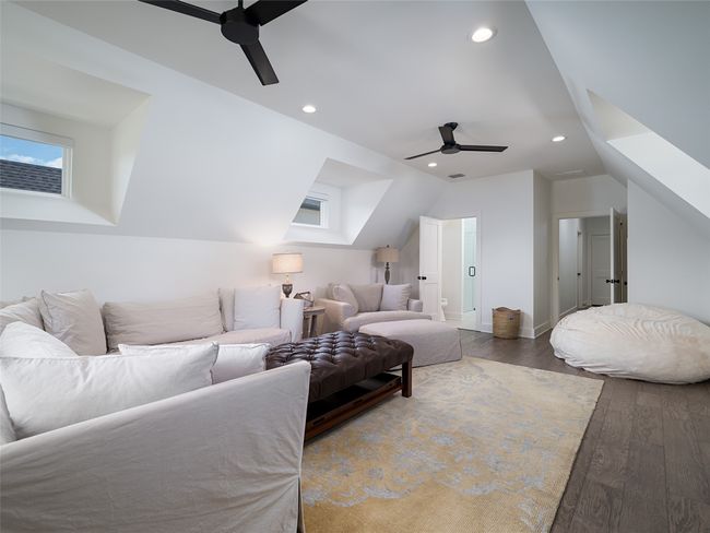 Bedroom featuring wood finished floors, lofted ceiling, recessed lighting, and a ceiling fan | Image 26