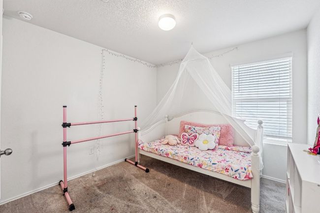 Bedroom featuring carpet flooring, a textured ceiling, and baseboards | Image 16
