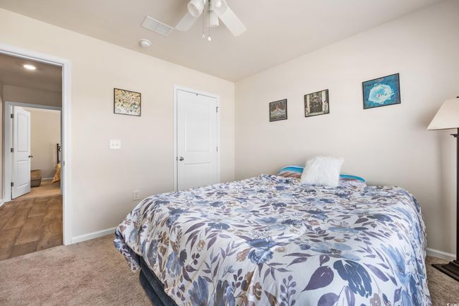Bedroom featuring carpet floors, baseboards, and a ceiling fan | Image 7