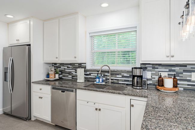 Ideal location for the sink with a window view that captures the backyard beauty. | Image 14