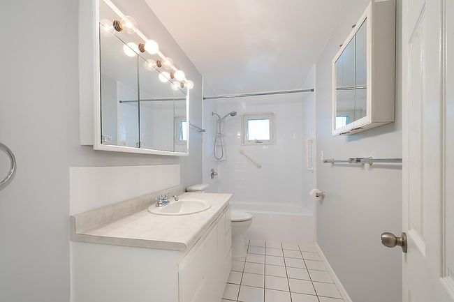 Bathroom featuring tile patterned flooring, shower combination, and vanity | Image 20