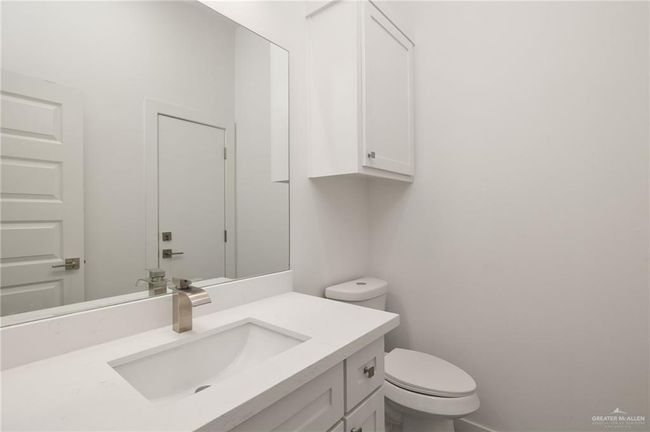 Half bathroom featuring vanity and toilet | Image 16
