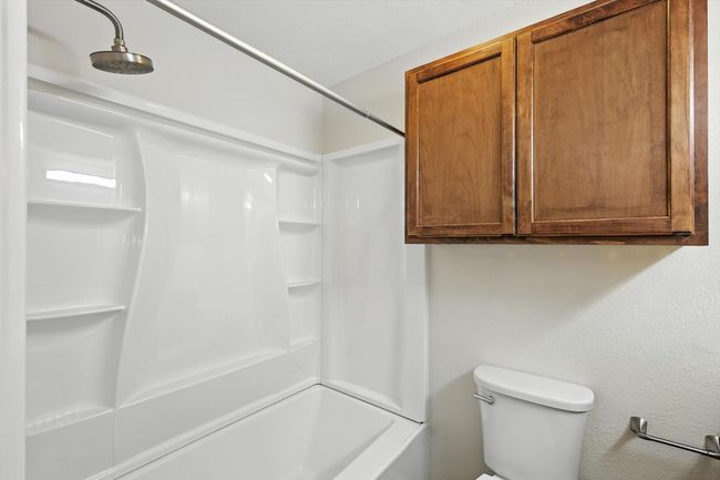 Bathroom with toilet and bathing tub / shower combination | Image 11