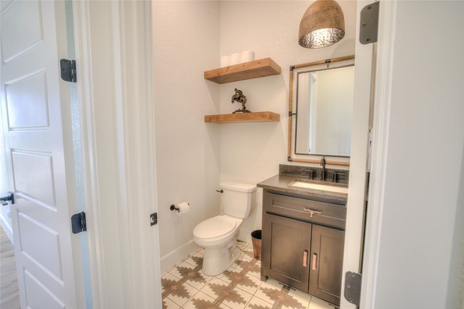 Bathroom with vanity, toilet, and baseboards | Image 12