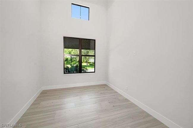 Den/Office featuring 15' high ceiling and light wood-type plank flooring. | Image 7