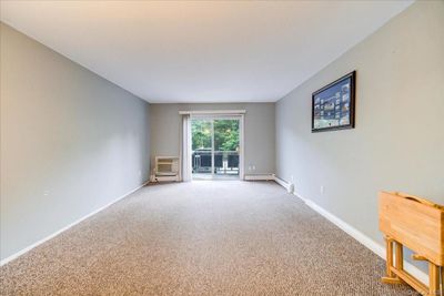 Living room with carpet and a wall unit | Image 3