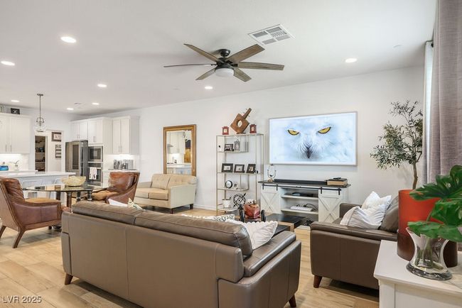 Living room featuring visible vents, ceiling fan, light wood finished floors, and recessed lighting | Image 12