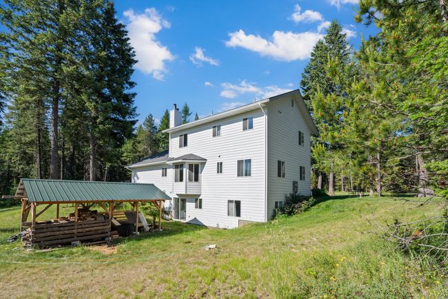 Back of property featuring a chimney and a yard | Image 5